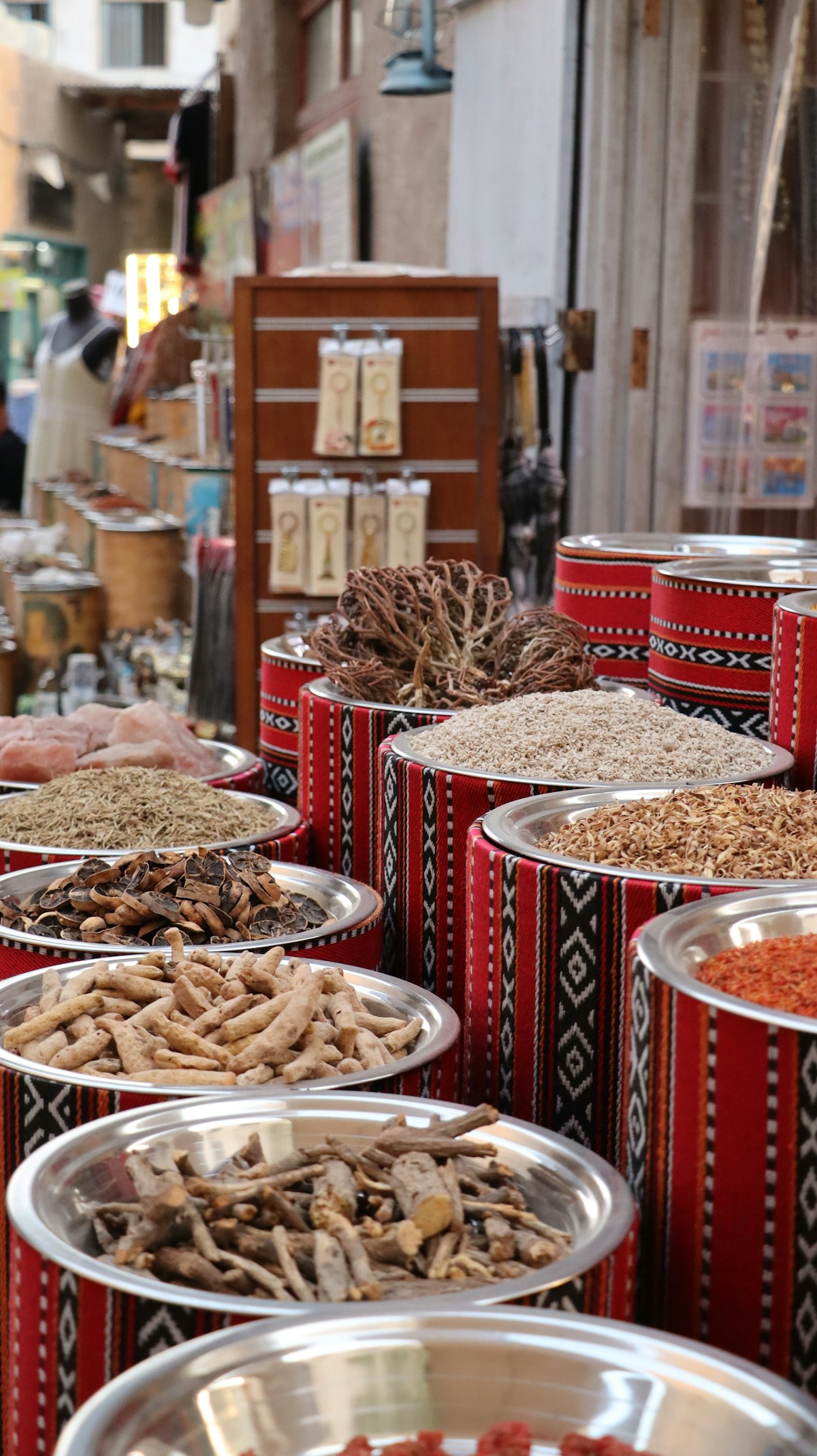 Bowls of dried herbs and botanicals at a market stall
